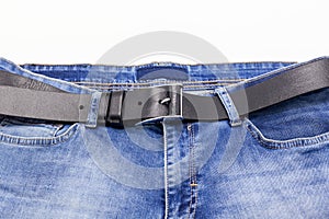 Denim pants with leather belt. Jeans trousers. Fashionable clothes. Trendy jean wear