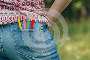 Denim pocket with colored pencils