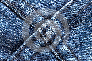 Denim or rough cotton fabric or jeans material with the stitched seam