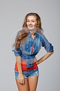 Denim style portrait of teen girl, over gray background