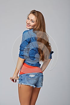 Denim style portrait of teen girl, over gray background