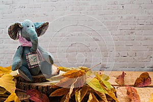 Denim textile elephant, the toy sits on wooden saws