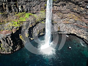 Denmark, Faroe Islands, Vagar Island, Gasadalur, village and waterfall falling into the sea