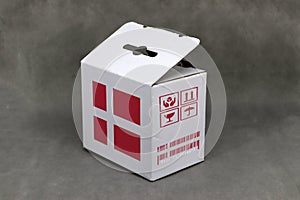Denmark flag on white box and nation flag barcode with fragile symbol. The concept of export trading from Denmark photo