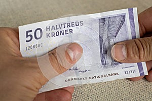 Denmark Money, Lowest 50 danish kroner banknote Held in hands, Financial and business concept