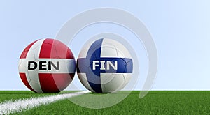 Denmark vs. Finland Soccer Match - Soccer balls in Denmark and Finlands national colors on a soccer field.