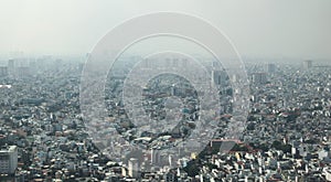 Dense air pollution and smog over Saigon, Vietnam Ho chi Minh City. Overpopulated city, urban sprawl. Aerial view. photo