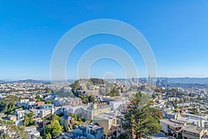 Dense apartment buildings and townhouses around the hill in the middle at San Francisco, CA