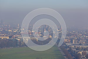 Dense smog over the city, air pollutant, aerial view of the old town Krakow, Poland.
