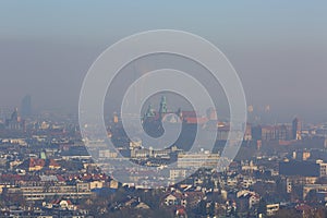 Dense smog over the city, air pollutant, aerial view of the old town Krakow, Wawel Castle, Poland.