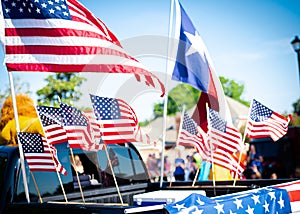 Dense of Texas and American flags on cargo bed of modern pickup truck driving on residential street smalltown Fourth of July
