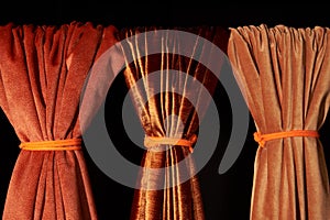 Dense textile and boucle textile which are golden in color hanging on the crossbar and folded. Background, texture