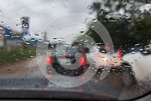 dense traffic on a rainy day with raindrops on car glasses