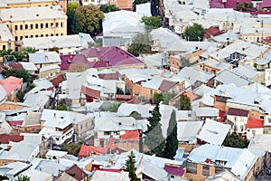 Dense urban development - a view of the roofs of houses from above. Overpopulation concept.