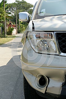 A dent on the right front of a pickup truck