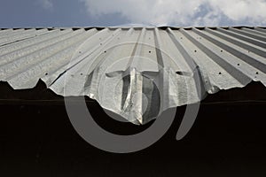 Dent on roof. Bent metal profile. Roof of building