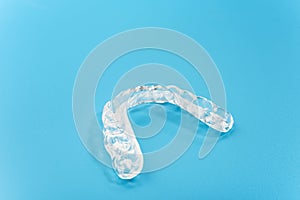 Dental aligner used by dental doctors isolated on blue background photo