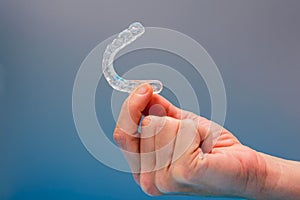 Dental aligner used by dental doctors isolated on blue background photo