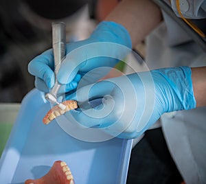 dental assistant cleaning dentures