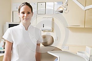 Dental assistant in exam room smiling