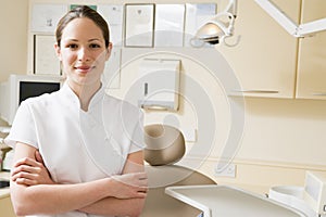 Dental assistant in exam room smiling photo