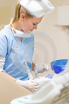 Dental assistant prepare equipment at stomatology photo