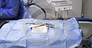 dental assistant prepares the medical table and lays out the sterilized instruments