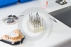 Dental burs and dental articulator in a lab.