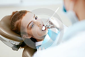 Dental Care. Girl During Dental Treatment In Dentistry Clinic