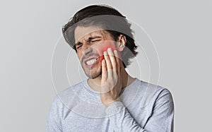 Dental care and health concept. Despaired man endure pain photo