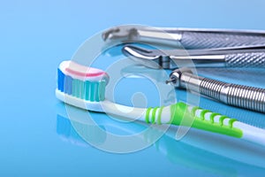 Dental care toothbrush with dentist tools on mirror background