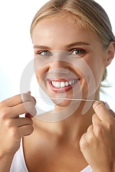 Dental Care. Woman With Beautiful Smile Using Floss For Teeth