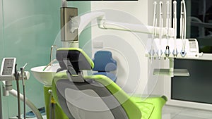 Dental chair with modern equipment placed in spacious office with cabinets and various tools in contemporary dentistry