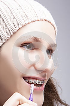 Dental Concepts. Portrait of Teenage Girl Using Bristle Brush for Cleaning Braces and Teeth
