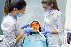Dental doctor using curing light.