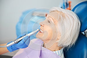 Dental drill with prophy cup cleaning pensioner teeth