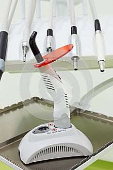 Dental drills and ultraviolet curing light tool.