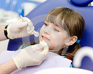 Dental examining being given to girl by dentist