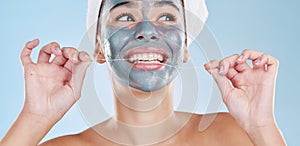 Dental, face mask and woman flossing teeth in a skincare beauty studio portrait with a blue background. Wellness, smile