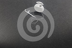 Dental floss on a gray background. Copy space