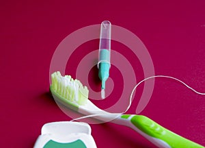 Dental floss, interdental brush and toothbrush