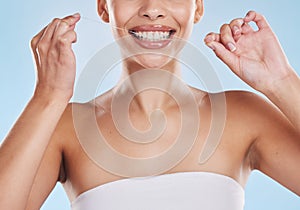 Dental floss, teeth and healthy smile with a beautiful young woman flossing for oral hygiene and gum health. Closeup of