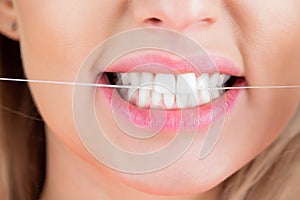 Dental flush - woman flossing teeth. Dental floss. Taking care of teeth. Healthy teeth concept. Teeths Flossing. Oral