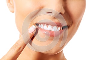 Dental health concept - beautiful woman pointing to her teeth