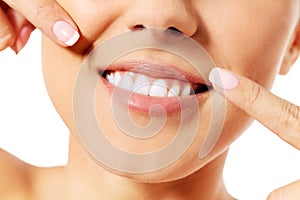 Dental health concept - beautiful woman pointing to her teeth