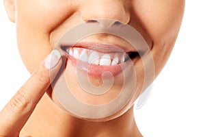 Dental health concept - beautiful woman pointing to her teeth