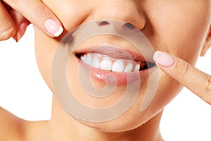 Dental health concept - beautiful woman pointing to her teeth