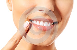 Dental health concept - beautiful woman pointing to her teeth