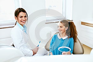 Dental Health. Dentist And Happy Girl In Dentistry Office