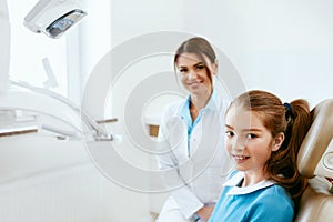 Dental Health. Dentist And Happy Girl In Dentistry Office photo